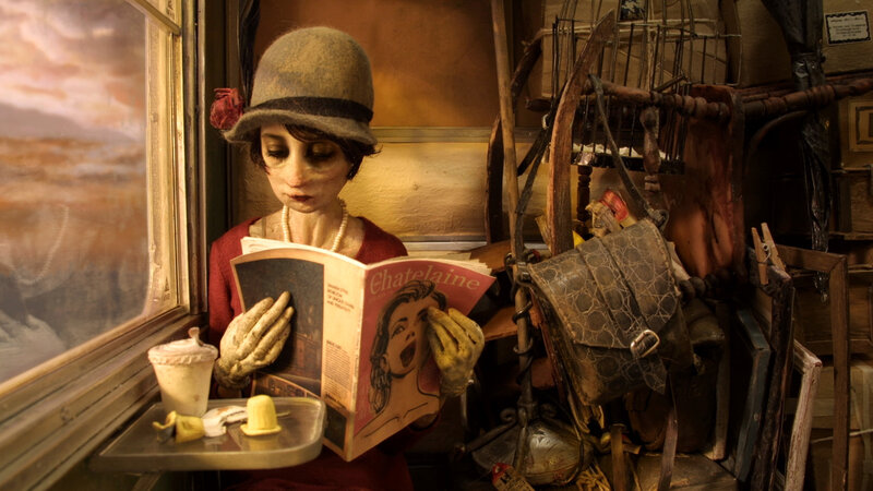 Puppet reading magazine on train