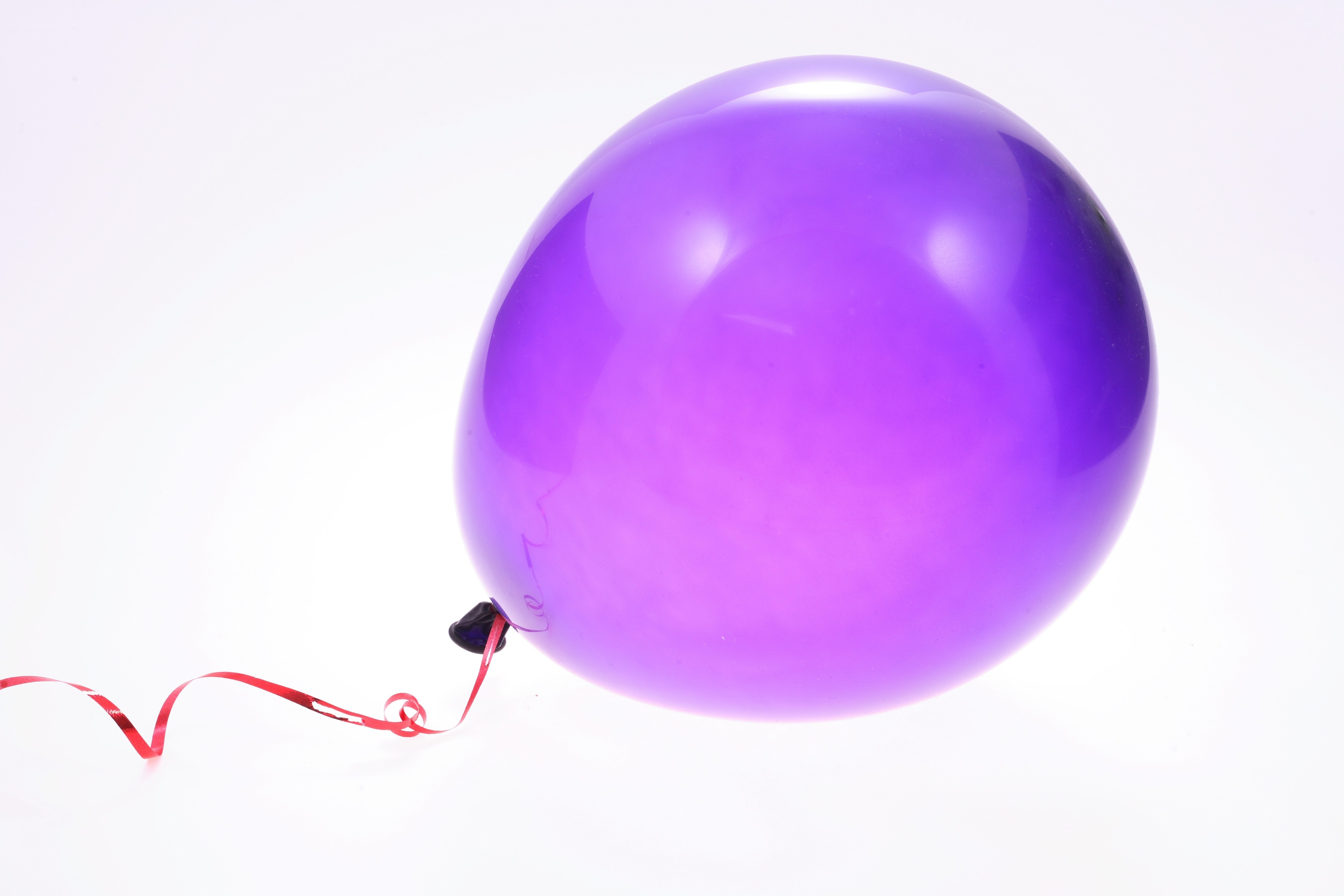 Purple balloon with red ribbon