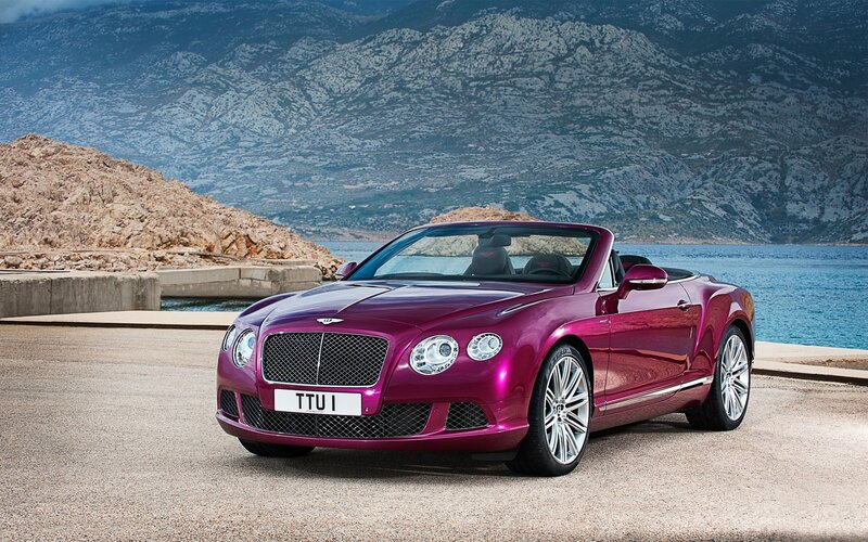 Purple Bentley convertible by the sea