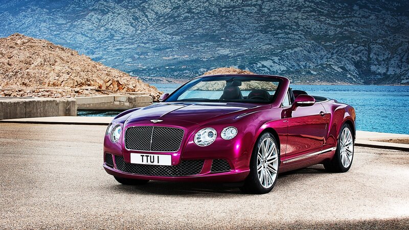 Purple Bentley convertible by the sea