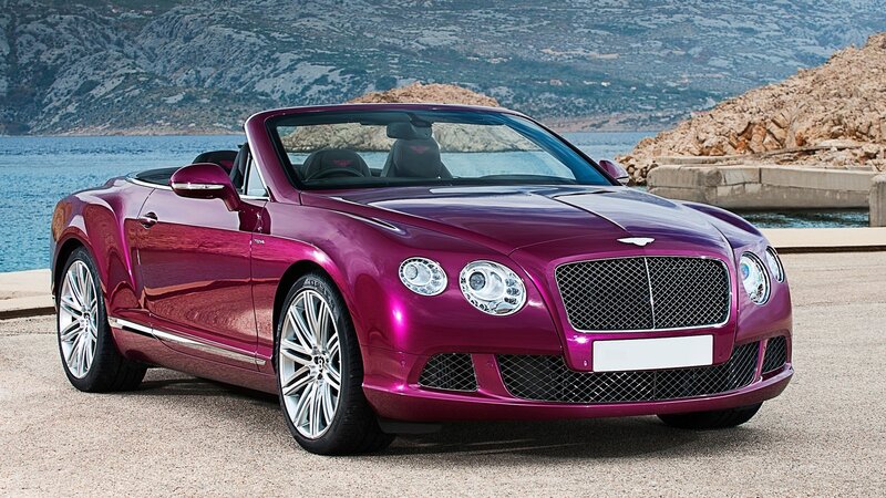Purple Bentley convertible by the sea