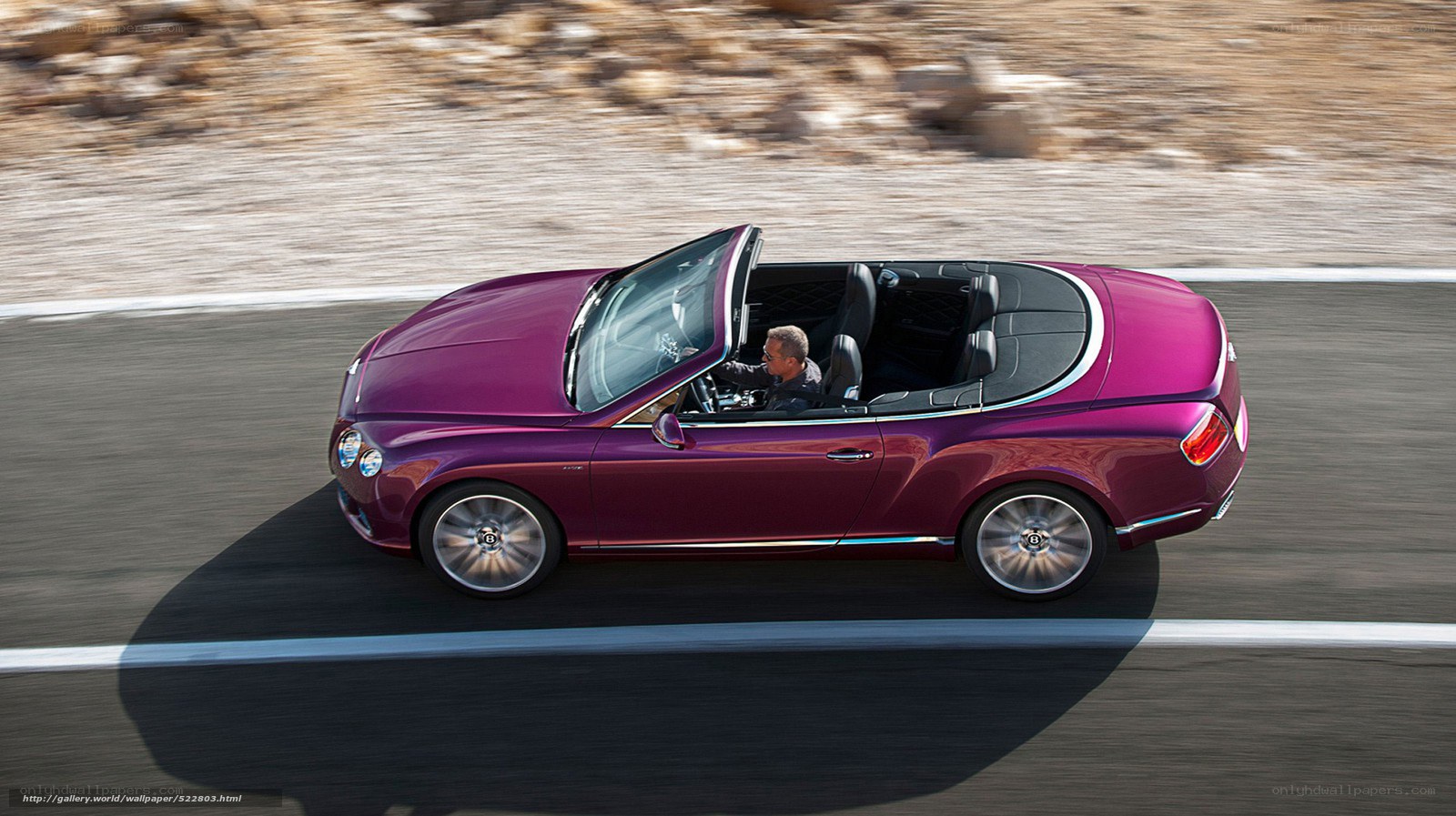 Purple Bentley convertible on road