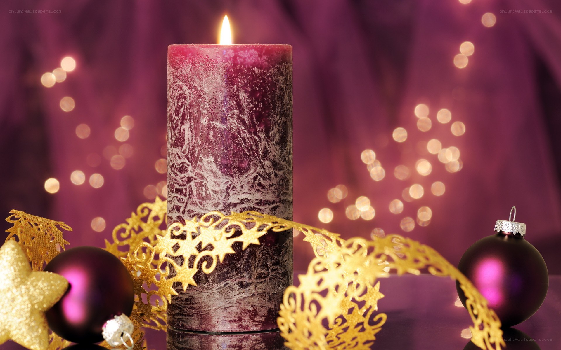 Purple candle with holiday decor
