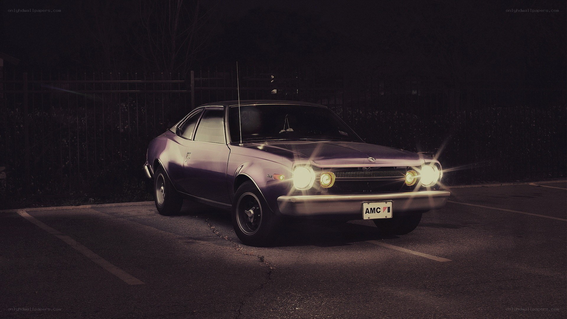 Purple car at night with headlights on