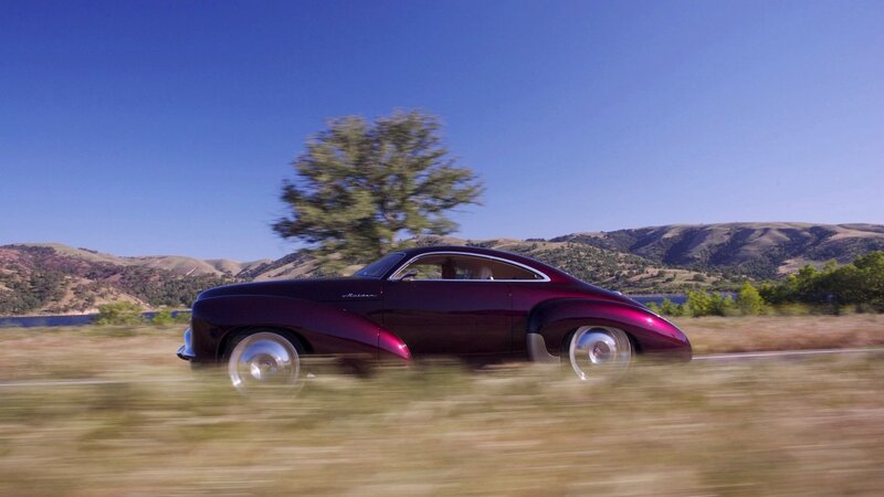 Purple car driving on country road