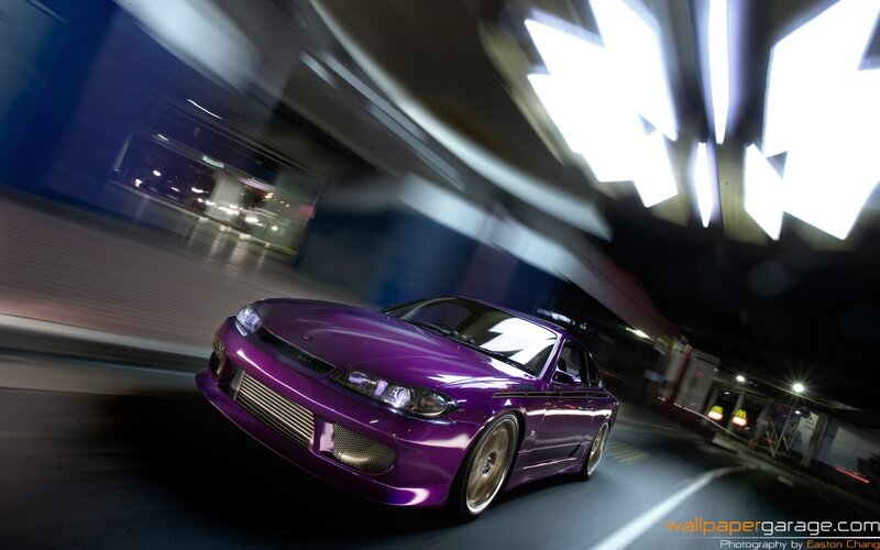 purple car in motion at night
