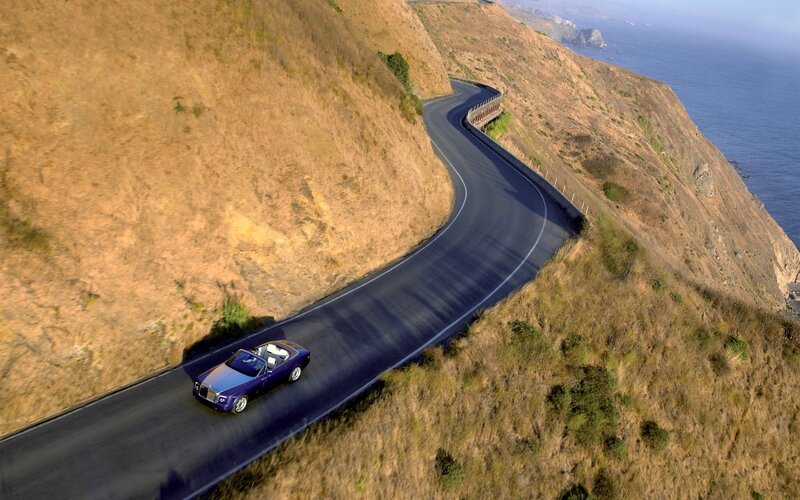 Purple car on coastal road