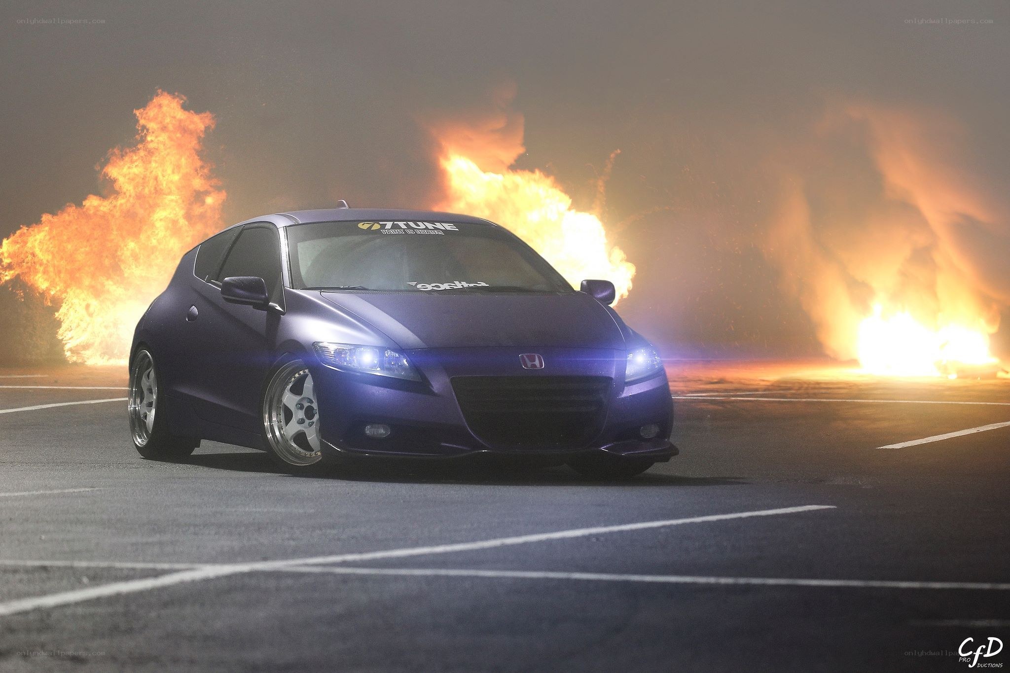 Purple car with fire in background