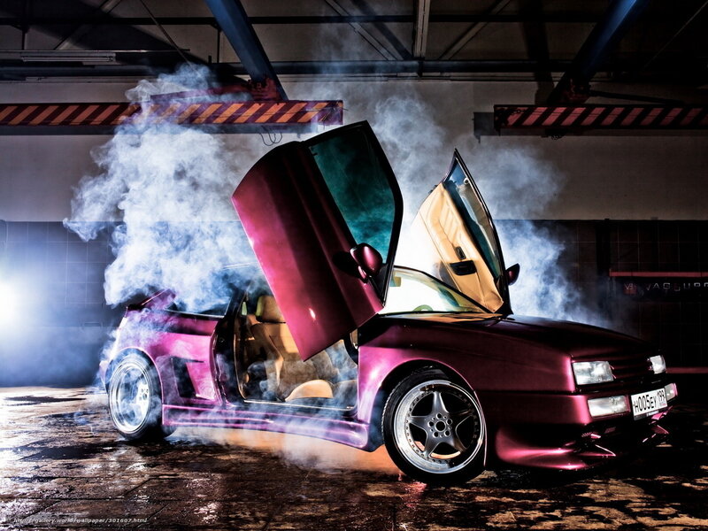 Purple car with open doors and smoke
