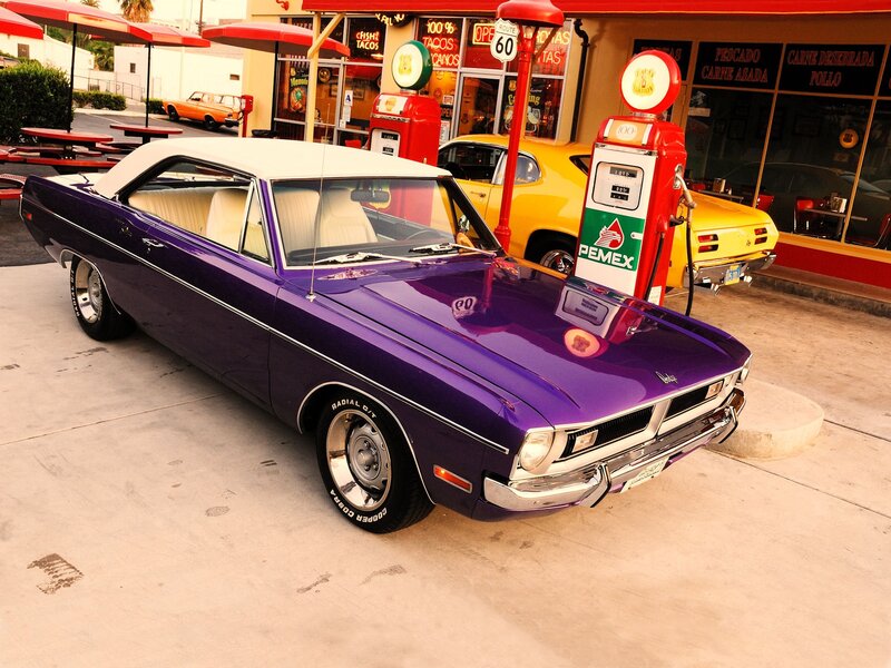 Purple classic car at gas station