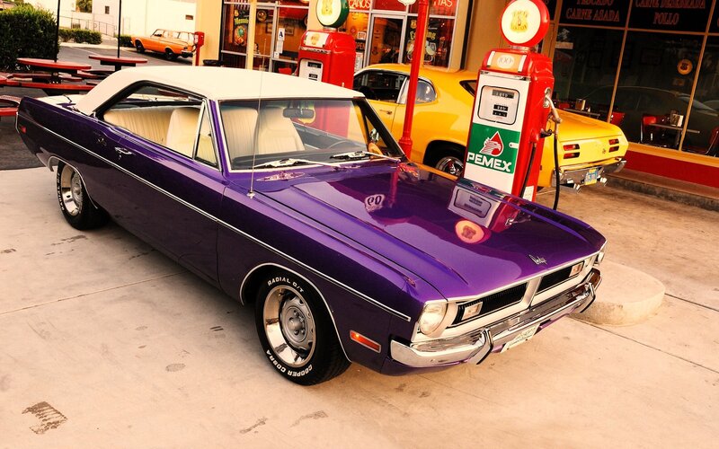 Purple classic car at gas station
