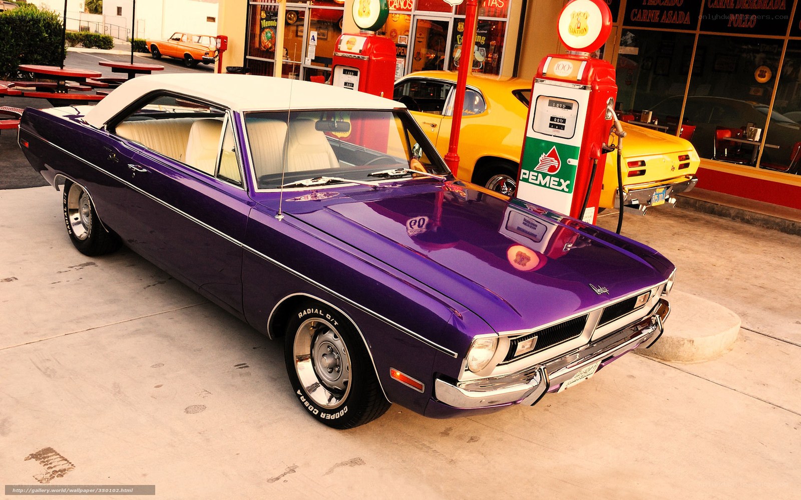 Purple classic car at gas station