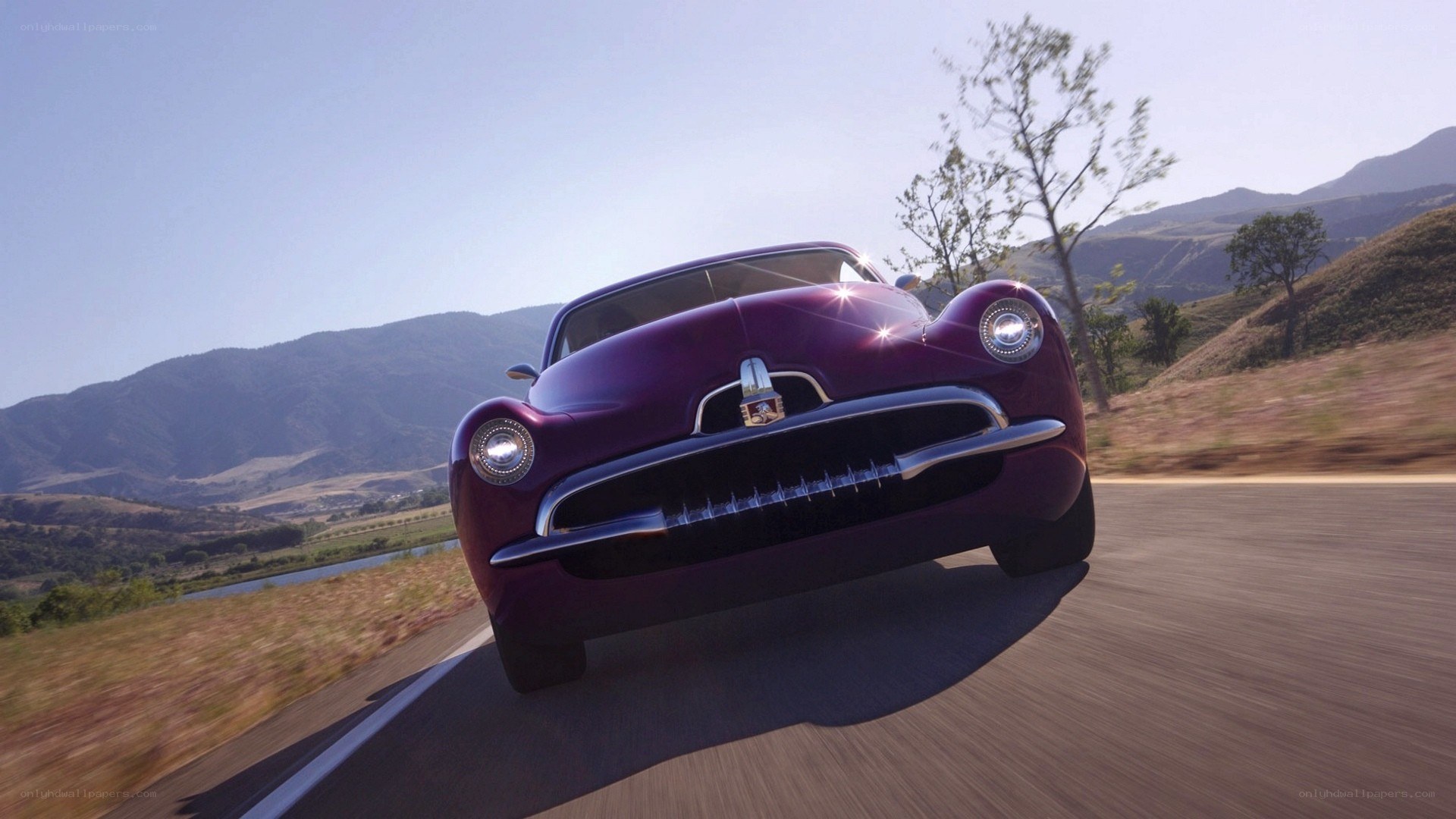 purple classic car on mountain road