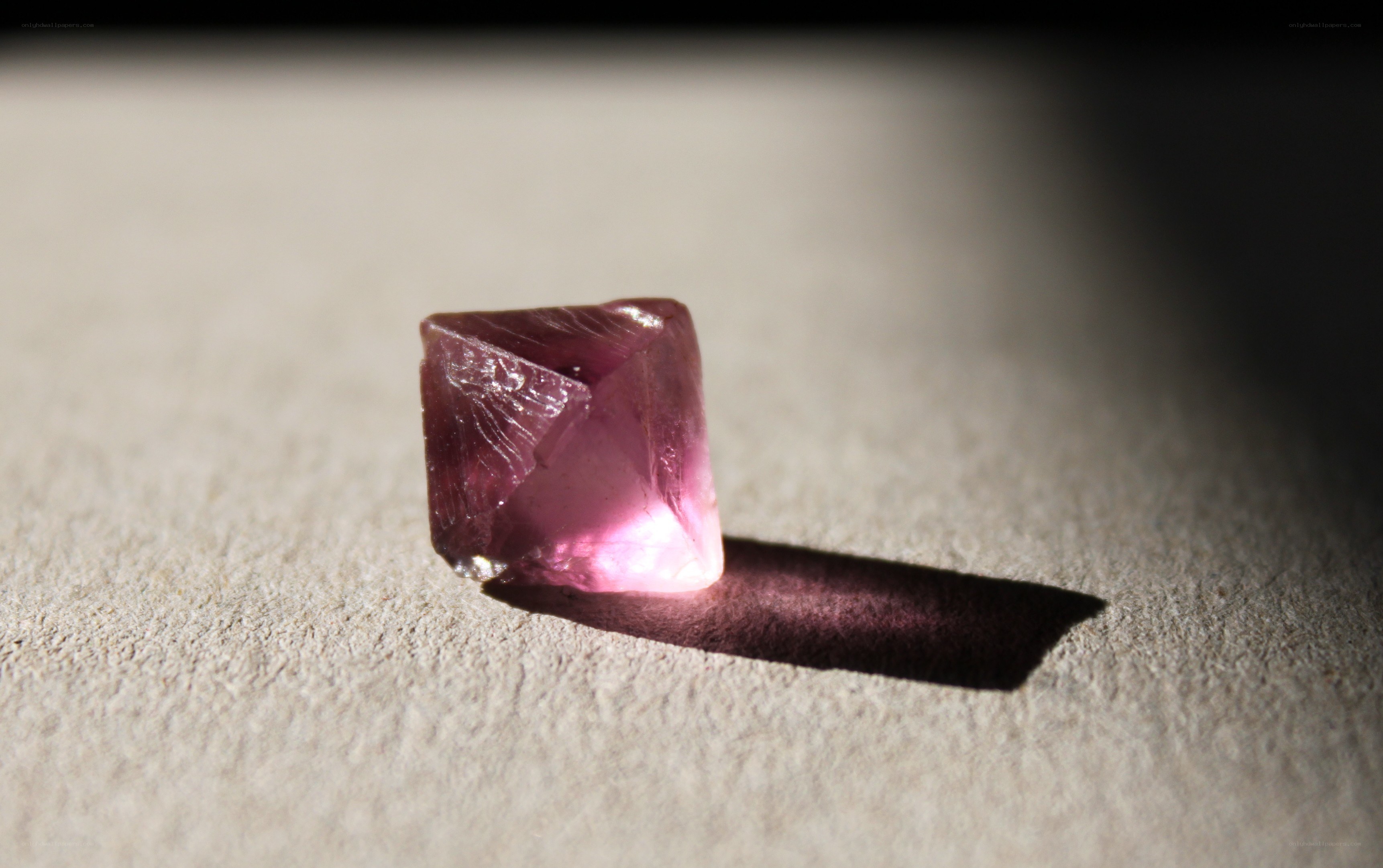 purple crystal on textured surface