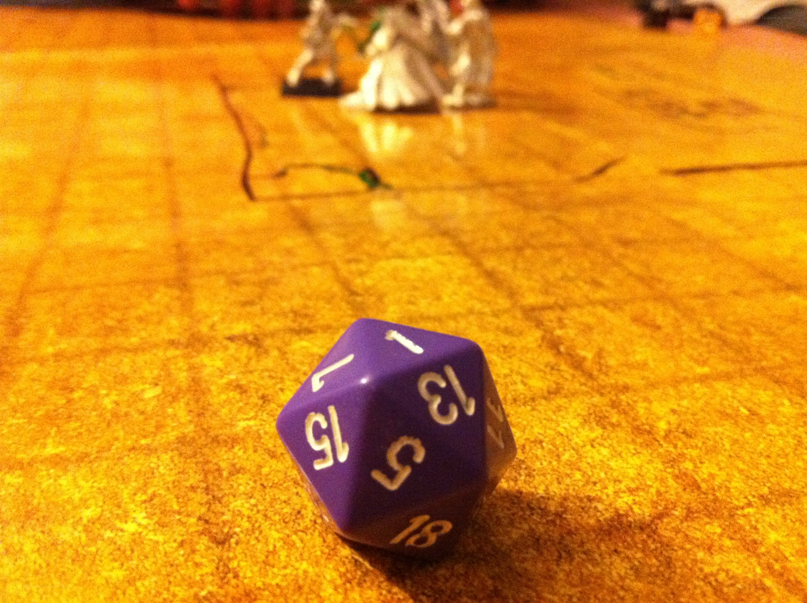 purple d20 on game mat
