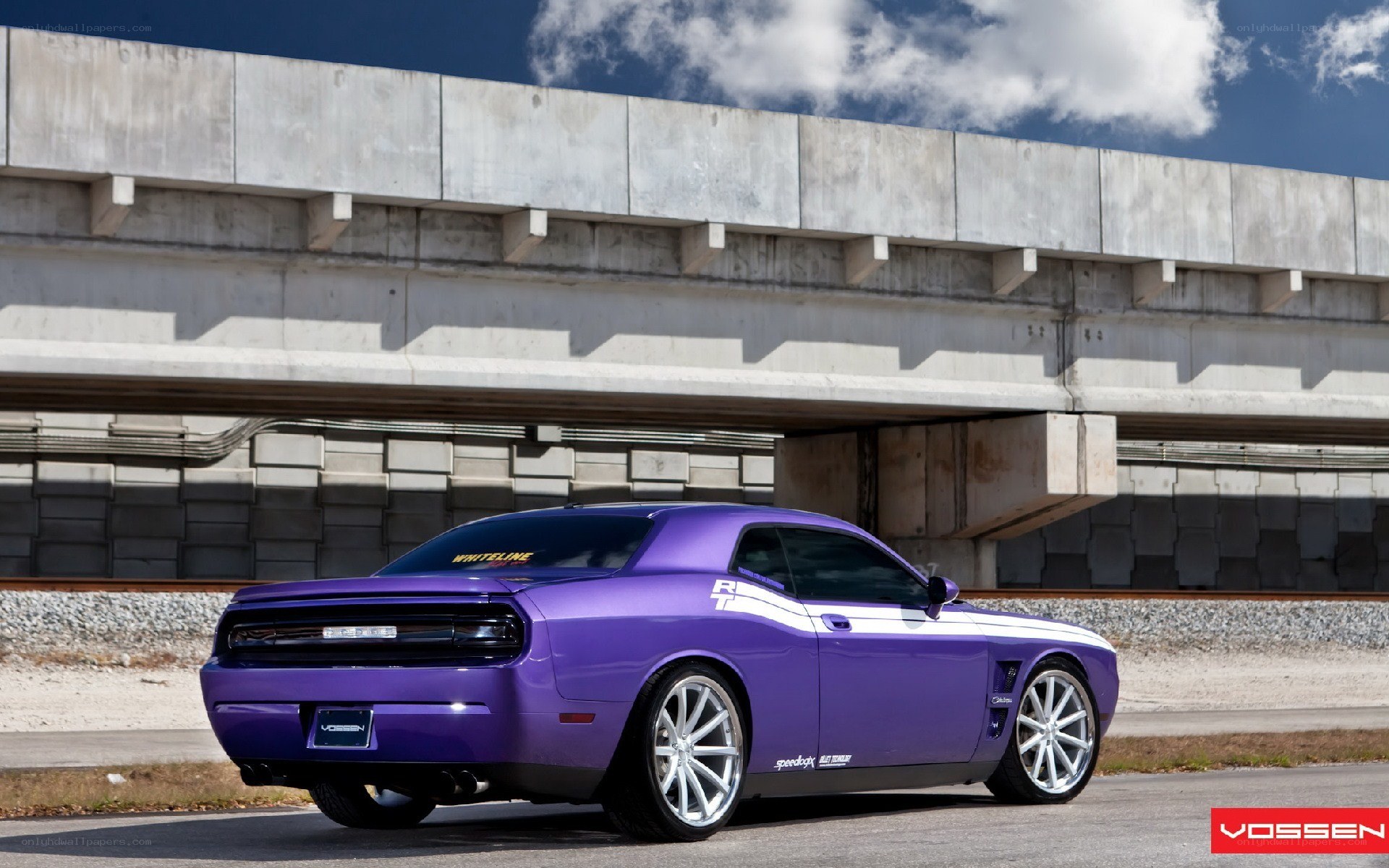 Purple Dodge Challenger under bridge