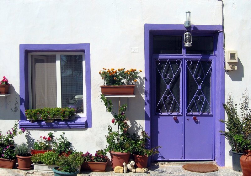 Purple door with potted plants