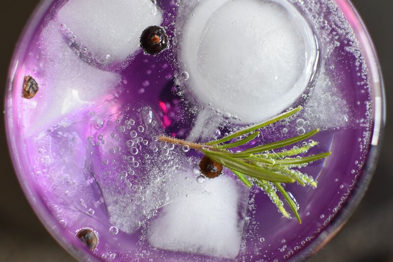 purple drink with ice and rosemary
