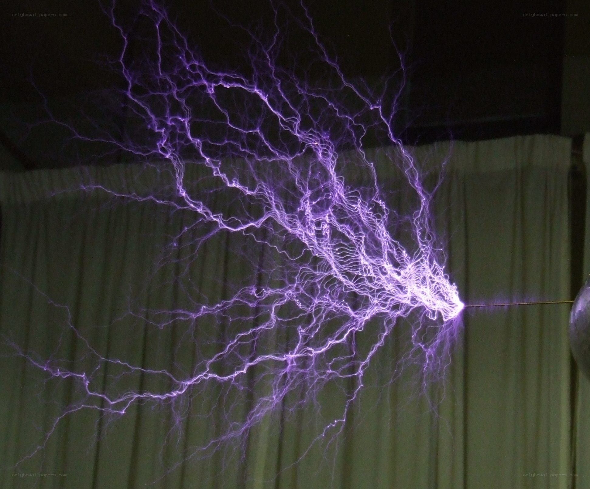 purple electrical arcs in a dark room