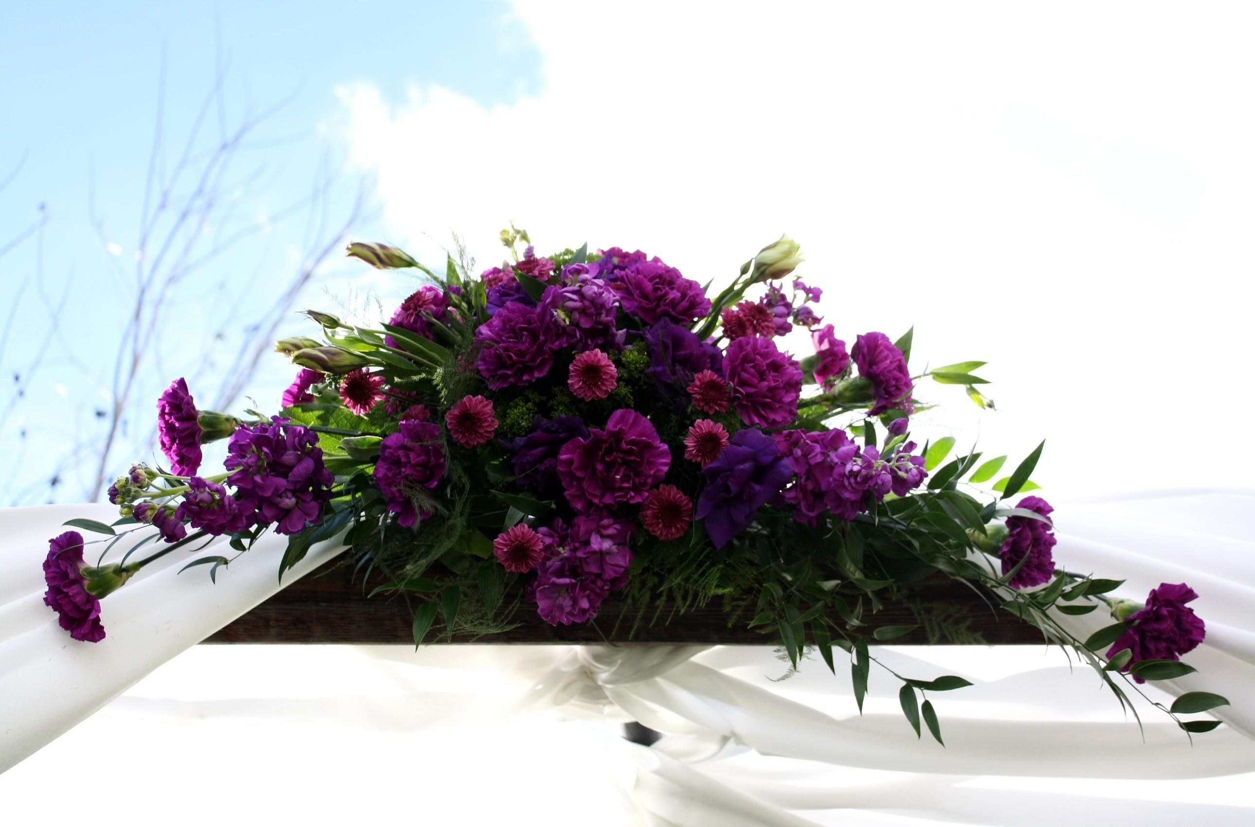 Purple floral arrangement on white drapery