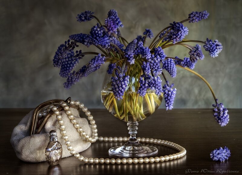Purple flowers and pearls still life
