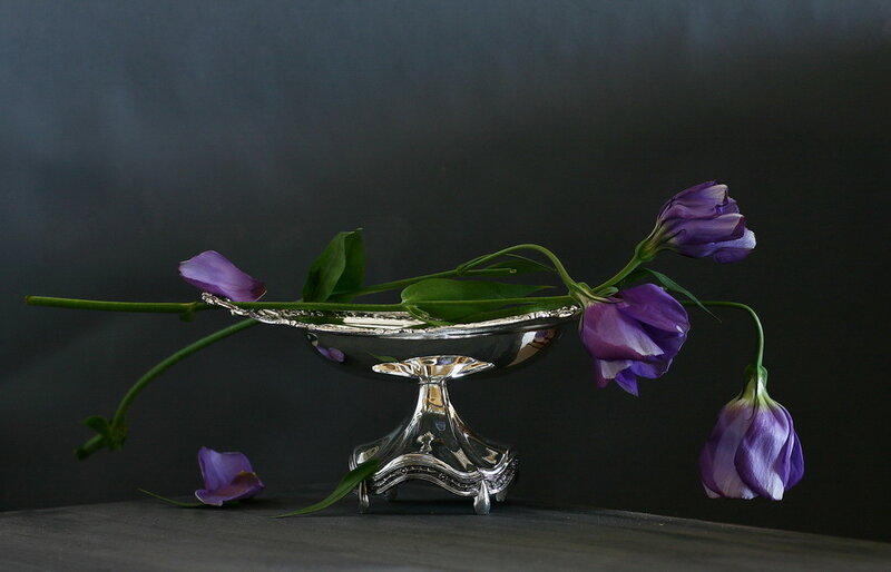 Purple flowers in silver bowl