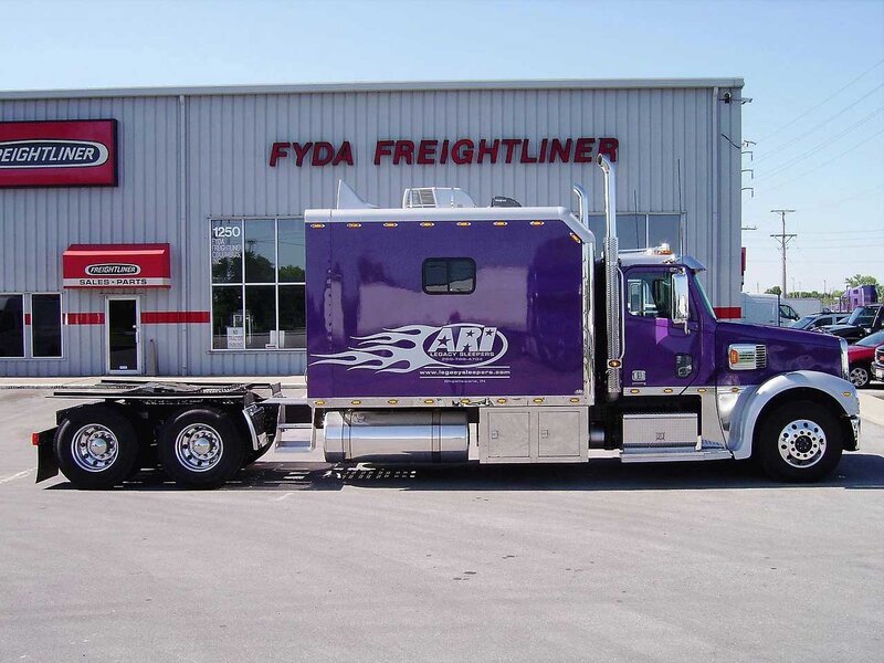 purple freightliner truck at dealership