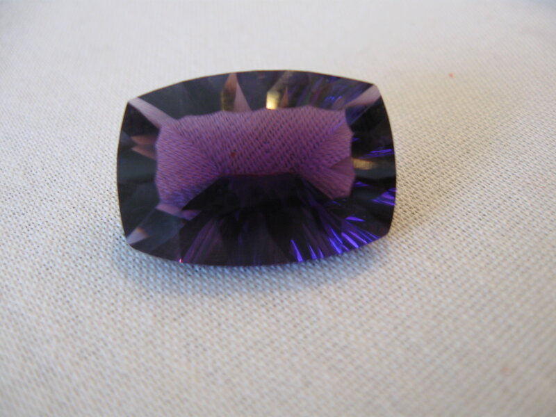 purple gemstone on fabric