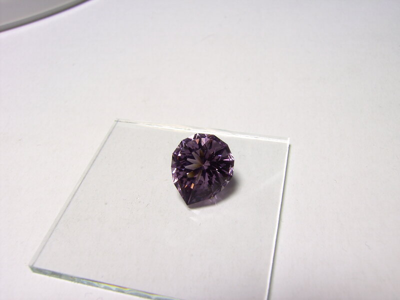purple gemstone on glass