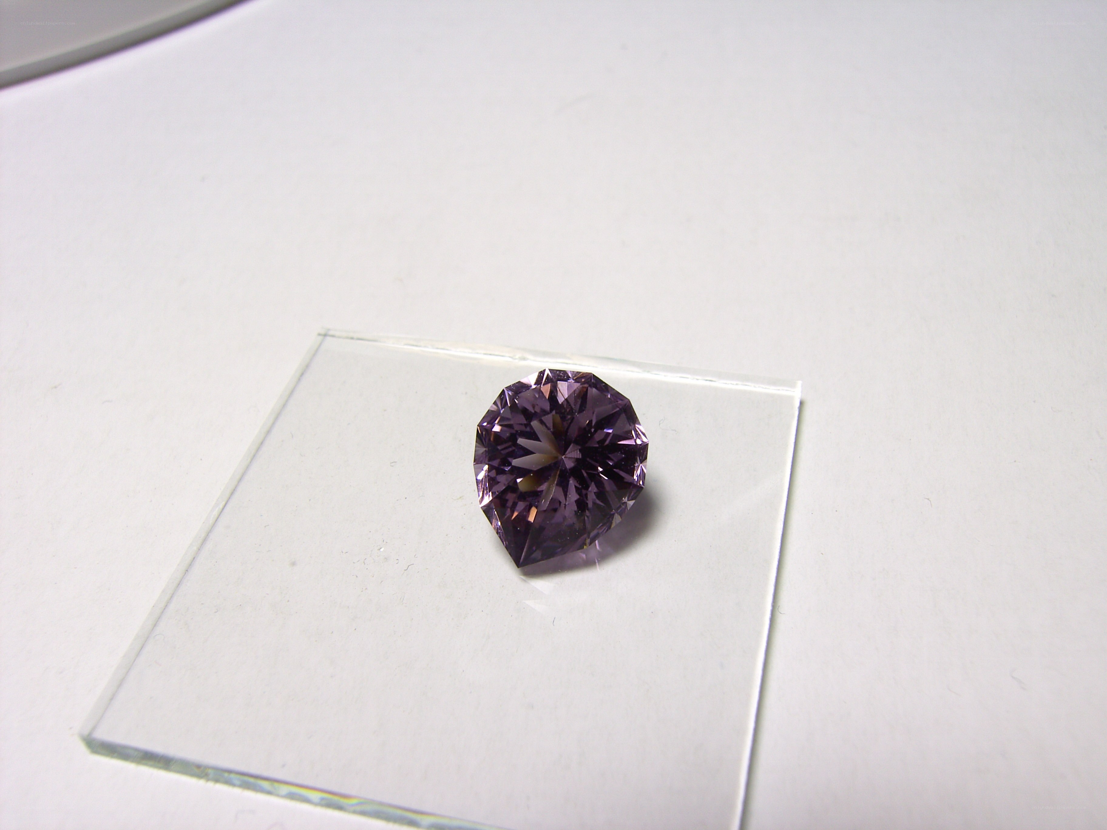 purple gemstone on glass