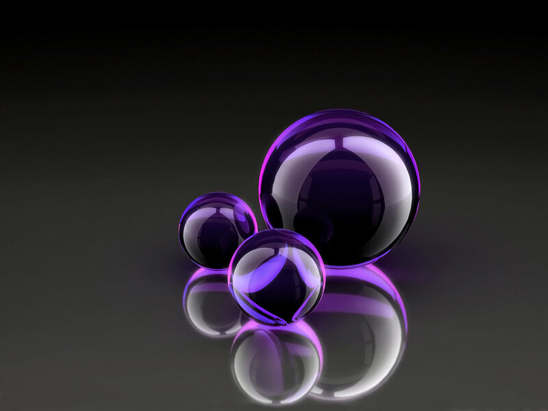 Purple glass spheres on dark surface