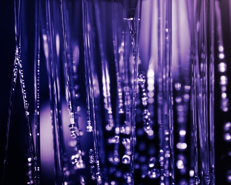 Purple glass tubes with water droplets