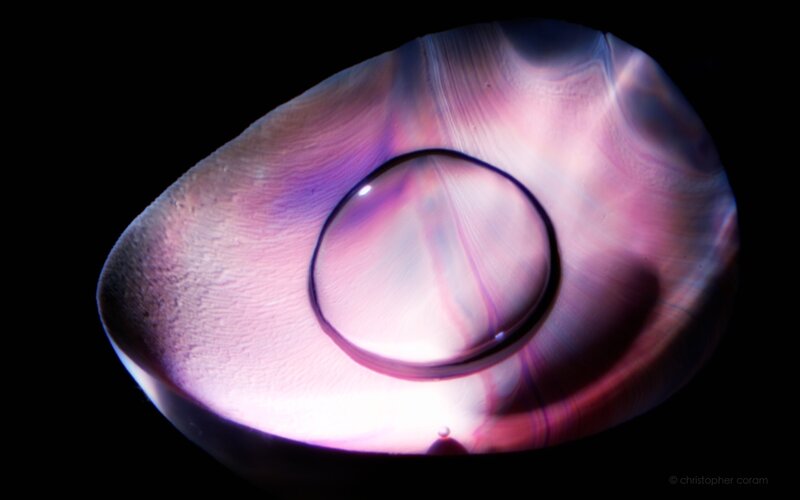 Purple glass with water droplet