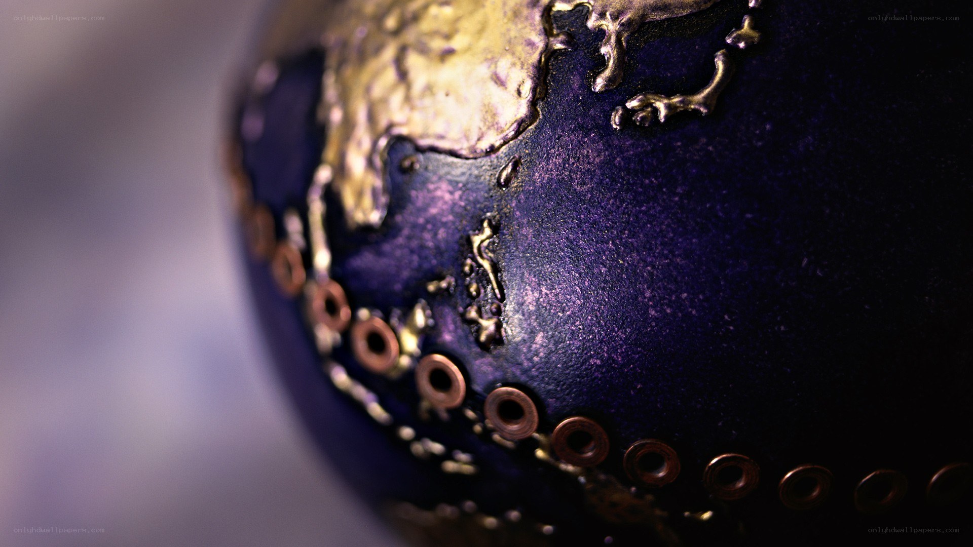 purple globe with gold continents