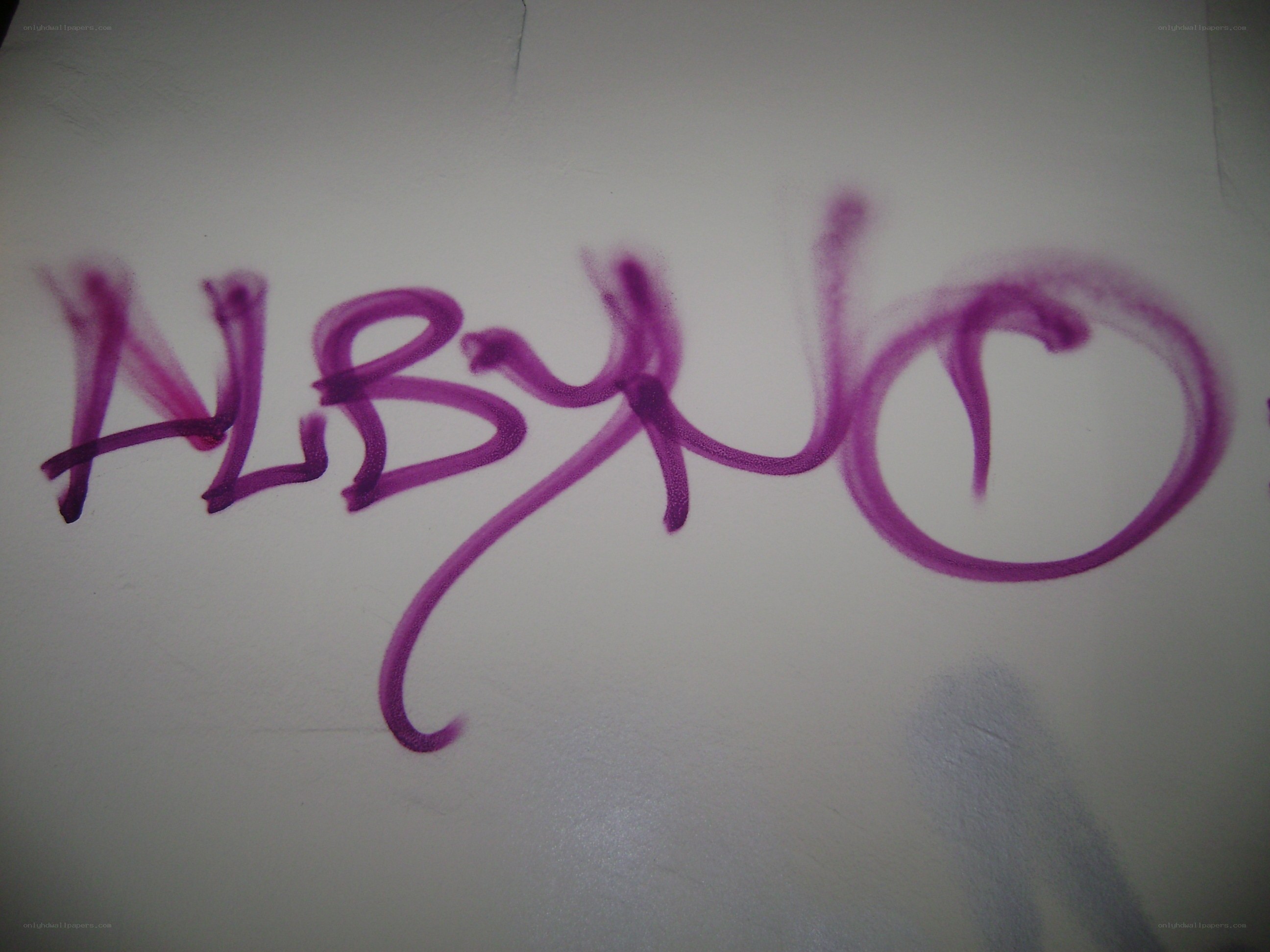 purple graffiti on white wall
