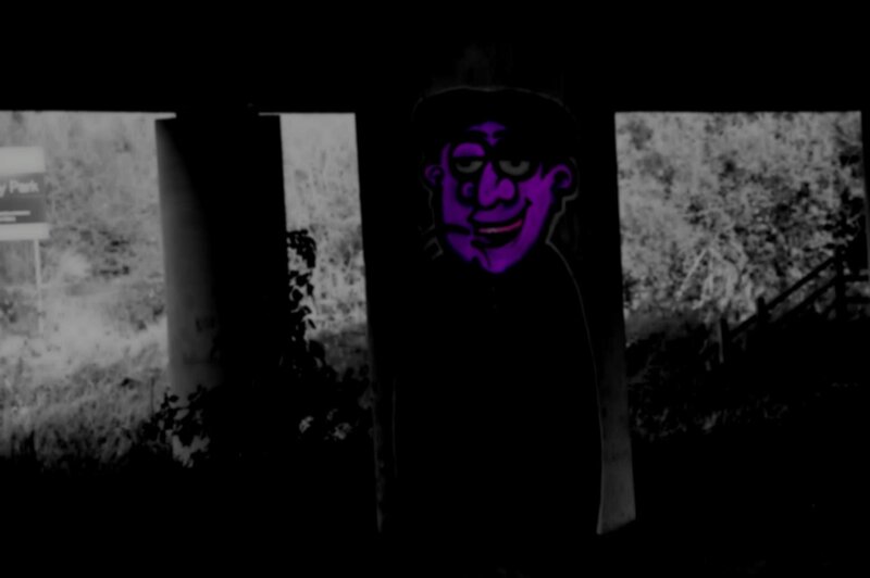 purple graffiti under bridge