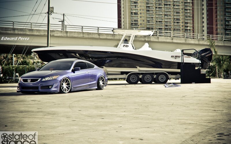 Purple Honda with boat trailer