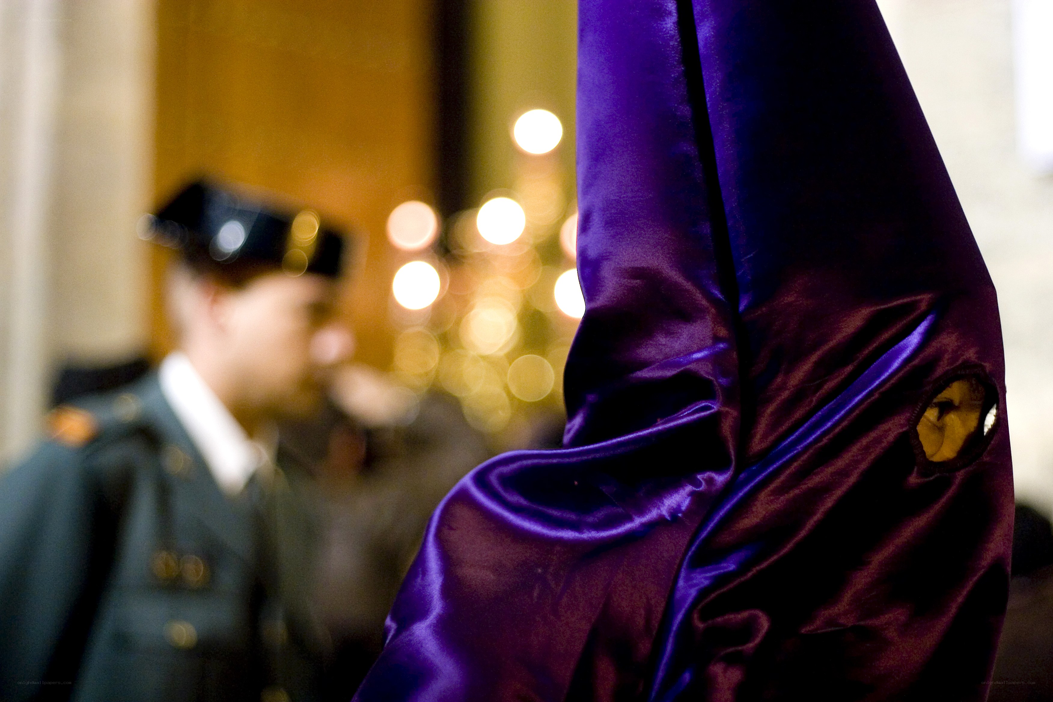 Purple hooded figure in procession