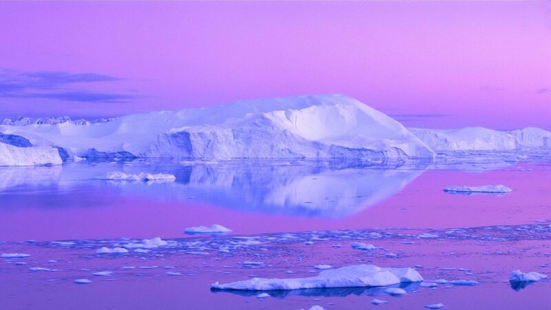 Purple-hued icebergs at dusk