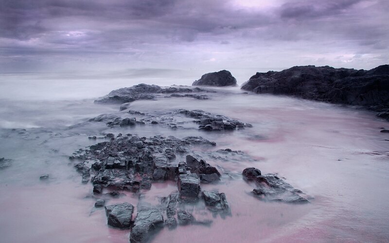 Purple-hued rocky shoreline