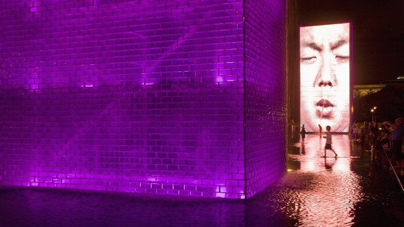 Purple illuminated brick wall at night