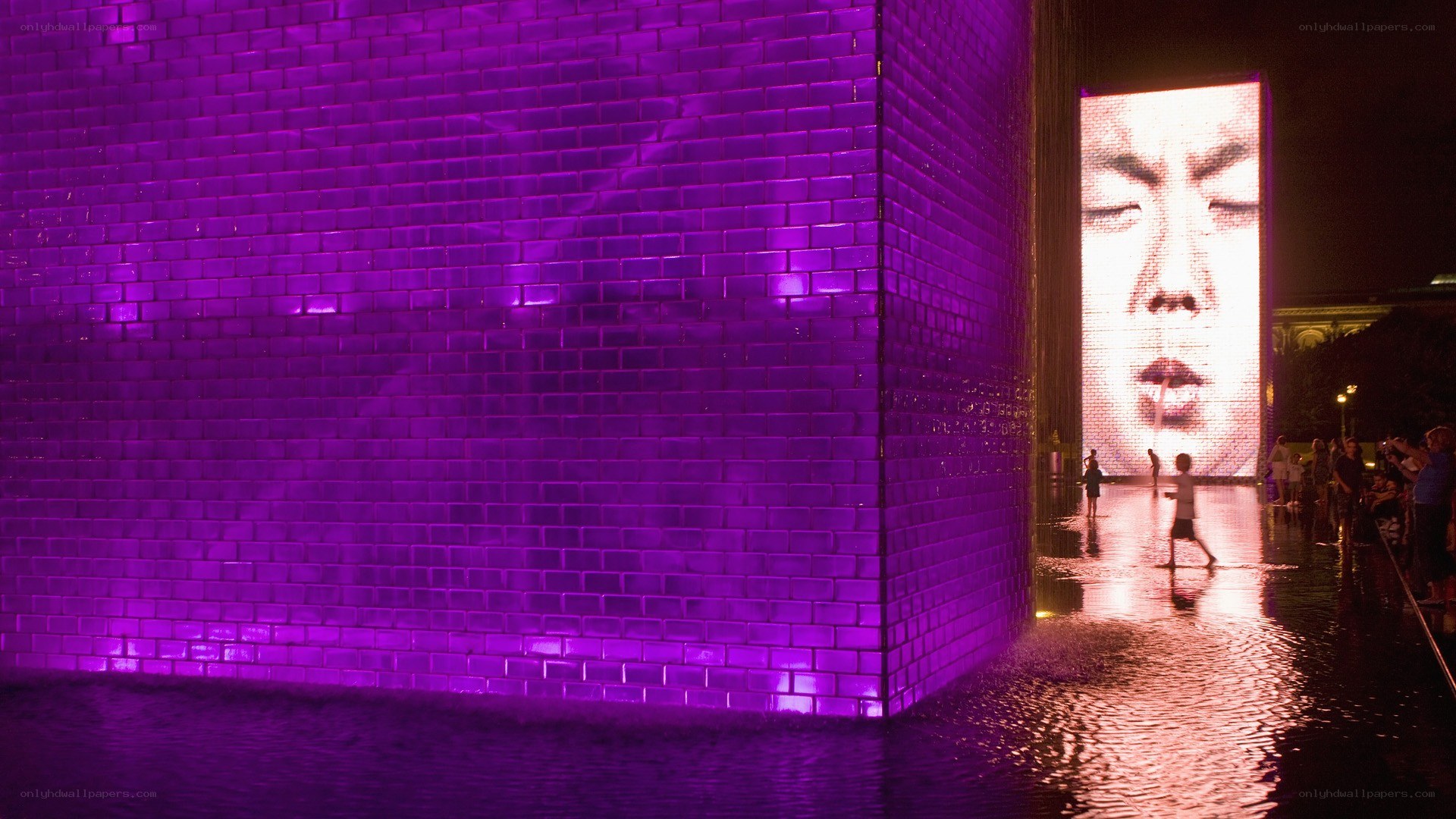 Purple illuminated brick wall at night