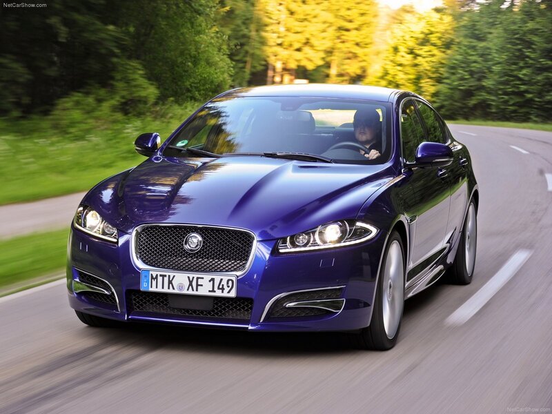 purple jaguar driving on road