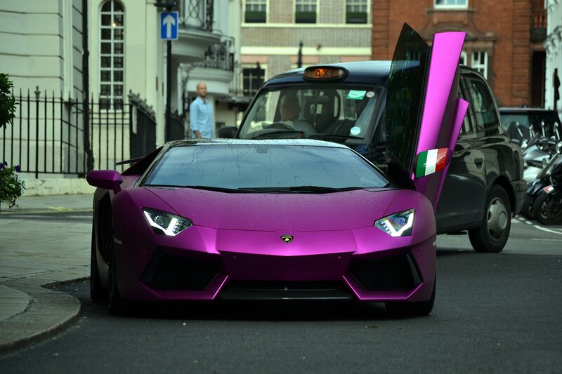 Purple Lamborghini on city street