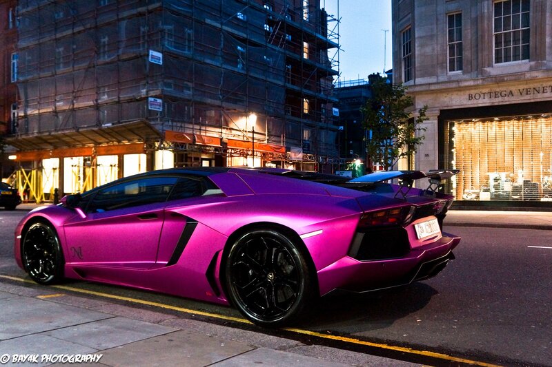 Purple Lamborghini on city street