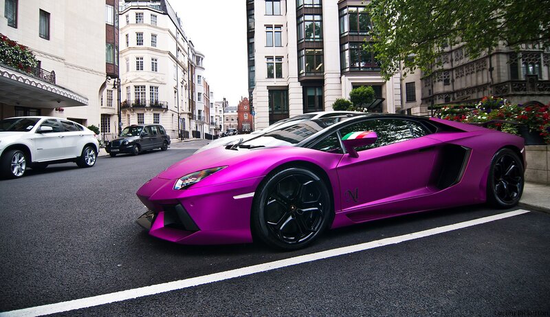 Purple Lamborghini on city street