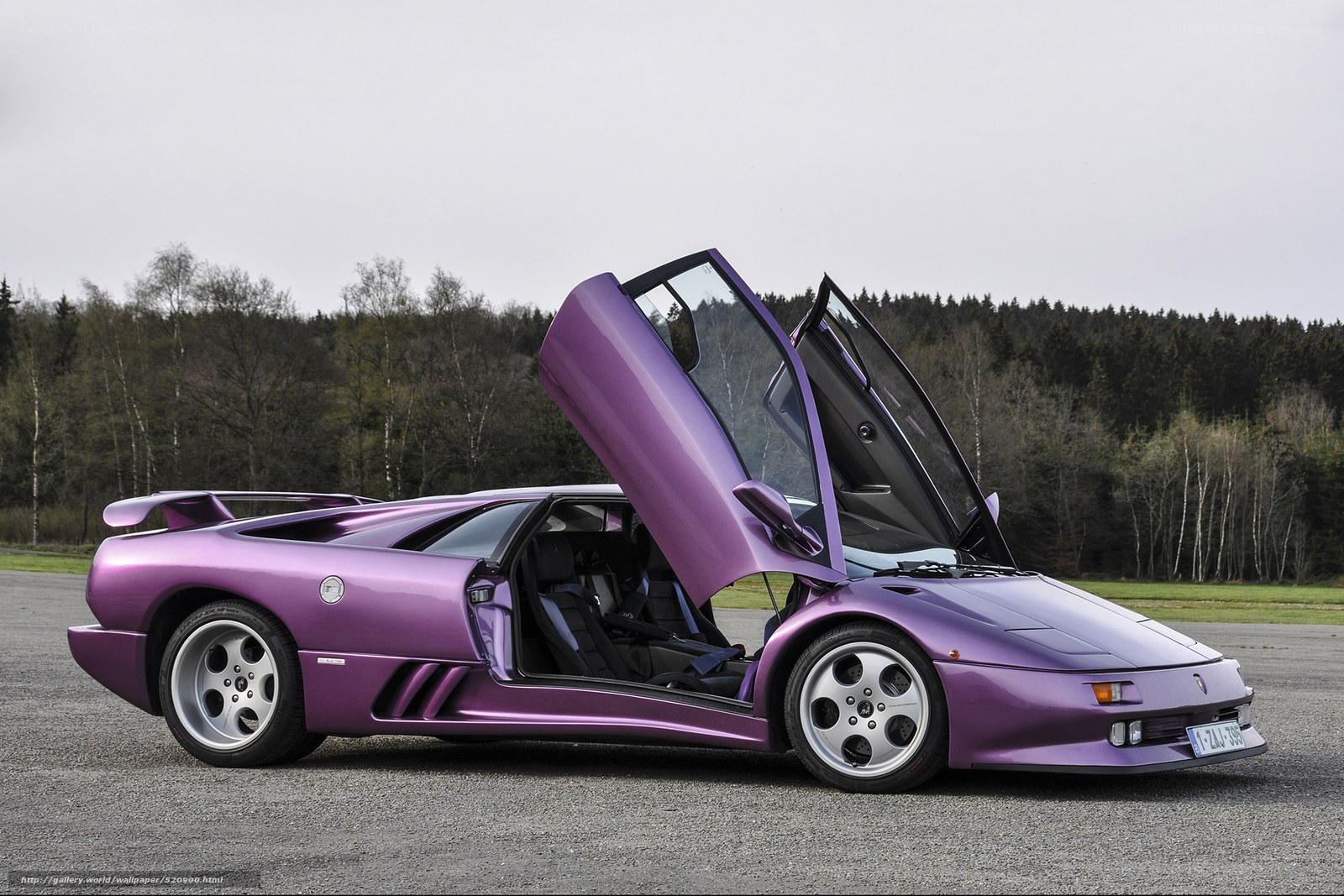 purple Lamborghini with doors open
