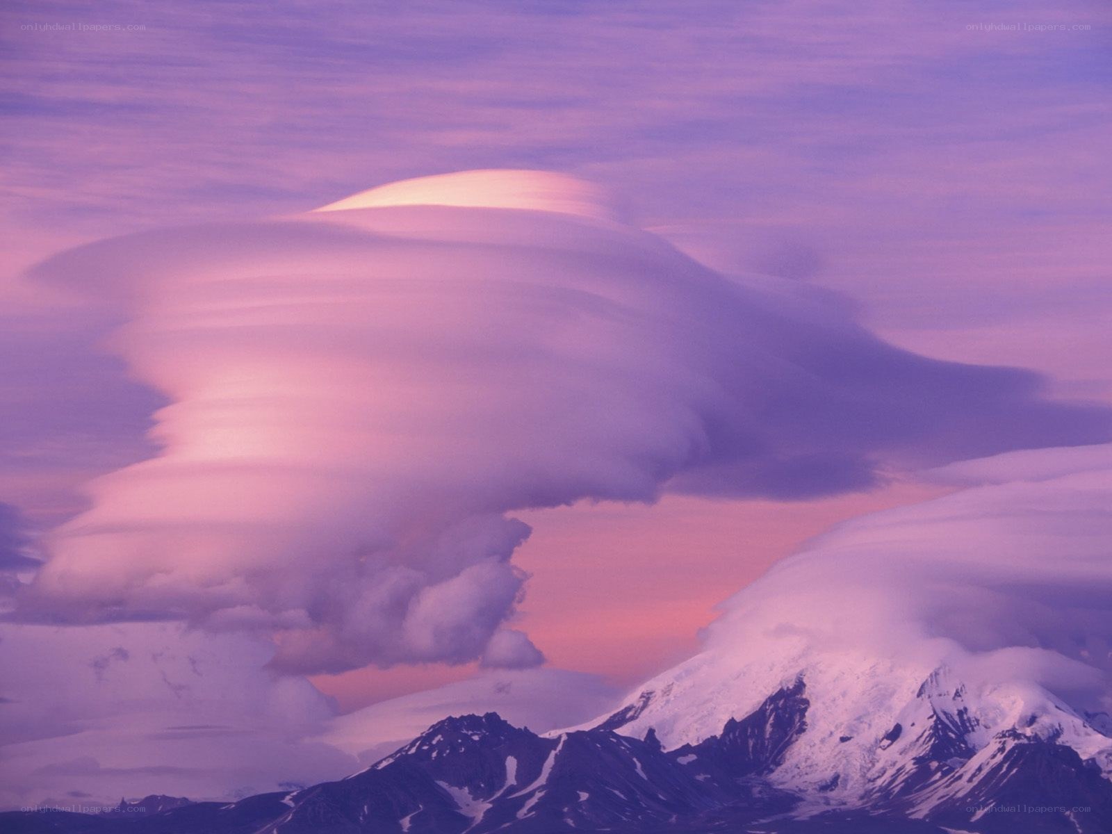 Purple lenticular cloud over mountains