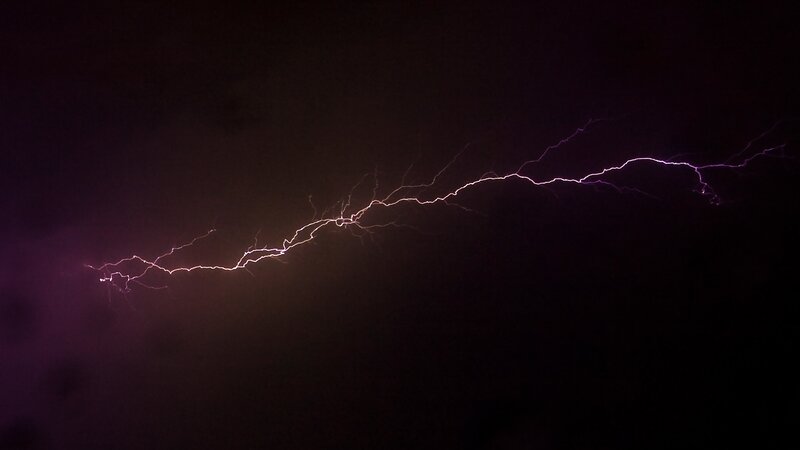 Purple lightning bolt in night sky