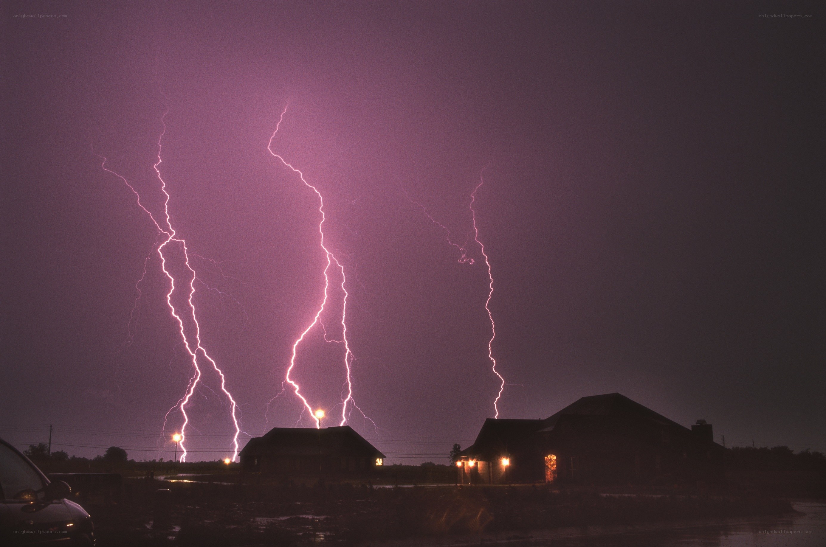 Purple lightning over houses